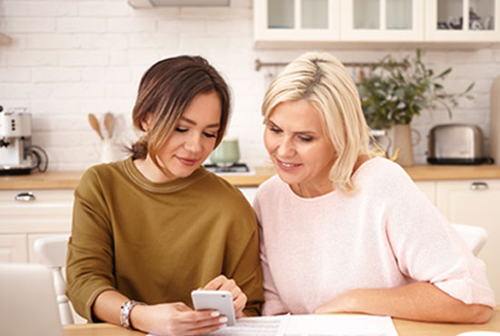 A high school girl discussing her career options with her mother in a beautiful white kitchen