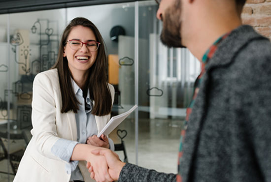 A college senior shaking hands to accept her first career job