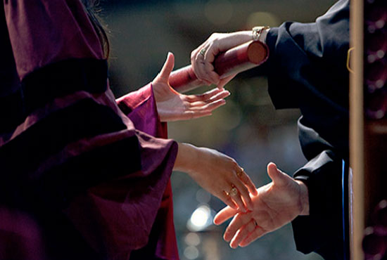 A college graduate receiving her diploma